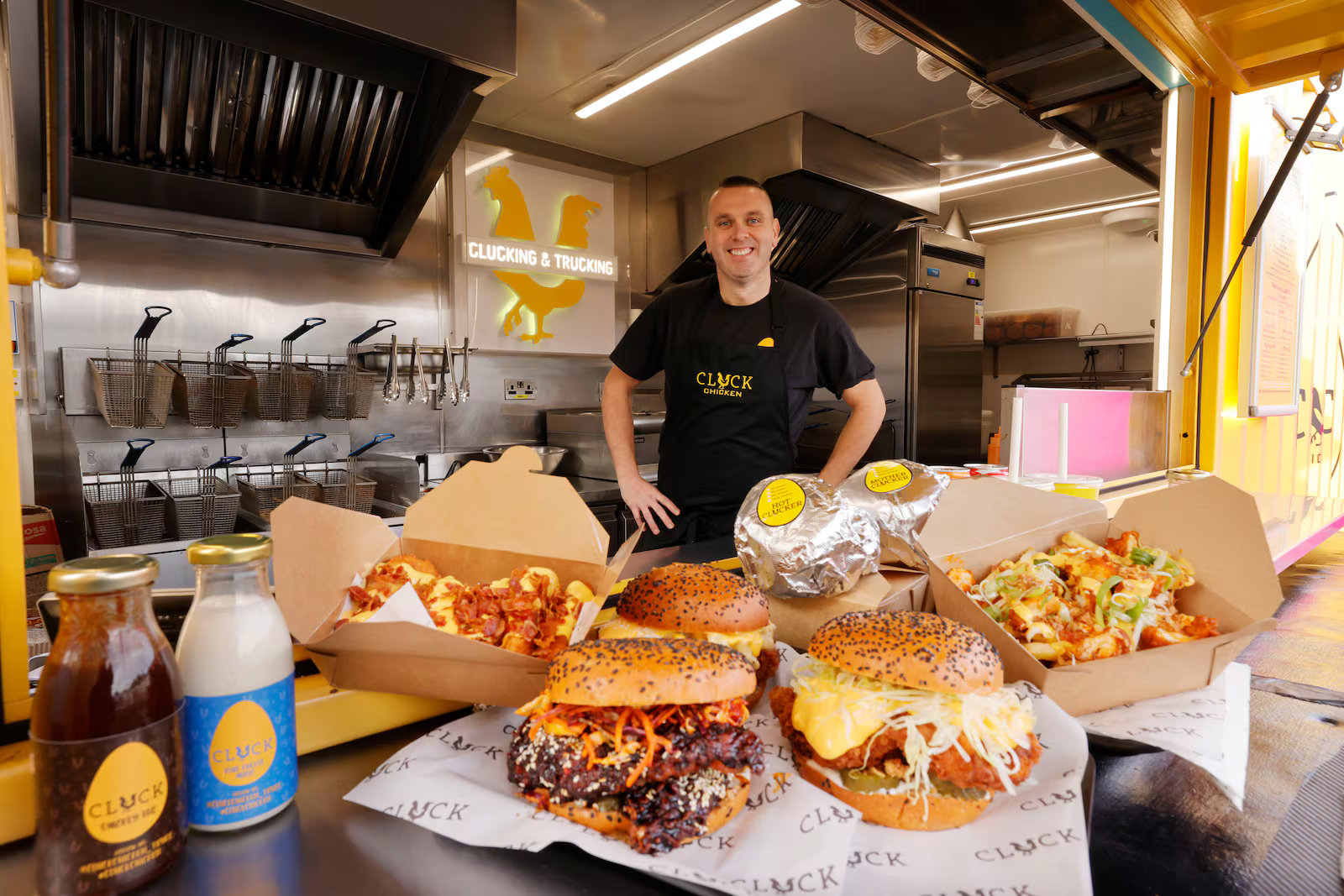 Chef Ian Ussher in the Cluck truck behind Hun Buns, loaded fries and Cluck sauces